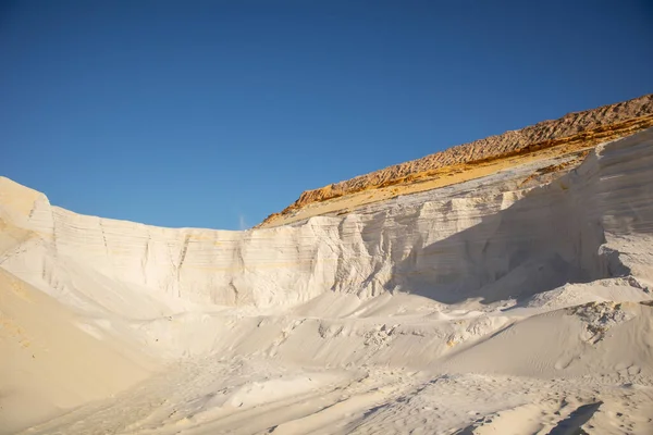 Embossed sand mountains of white sands. Desert landscape.