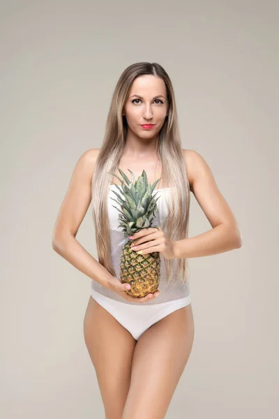 Menina bonita magro e apto com cabelo loiro longo em maiô branco. Pele brilhante — Fotografia de Stock