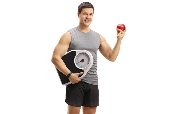Ung Man Sportkläder Holding Ett Äpple Och Vikt Skala Isolerad — Stockfoto