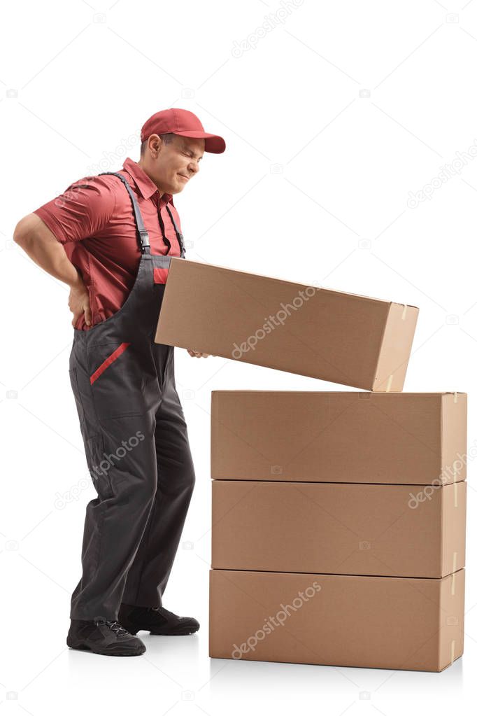 Full length profile shot of a mover lifting a package and experiencing back pain isolated on white background