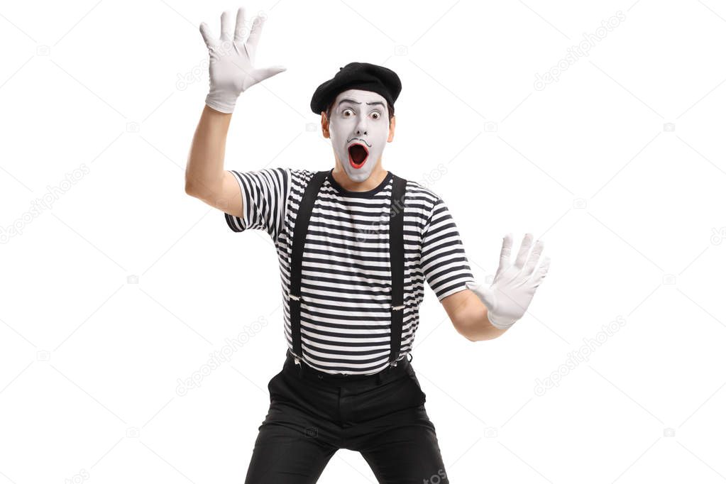 Mime holding his hands against an invisible wall isolated on white background