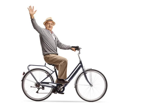 成熟した男は自転車に乗って 白い背景で隔離のカメラに手を振って — ストック写真