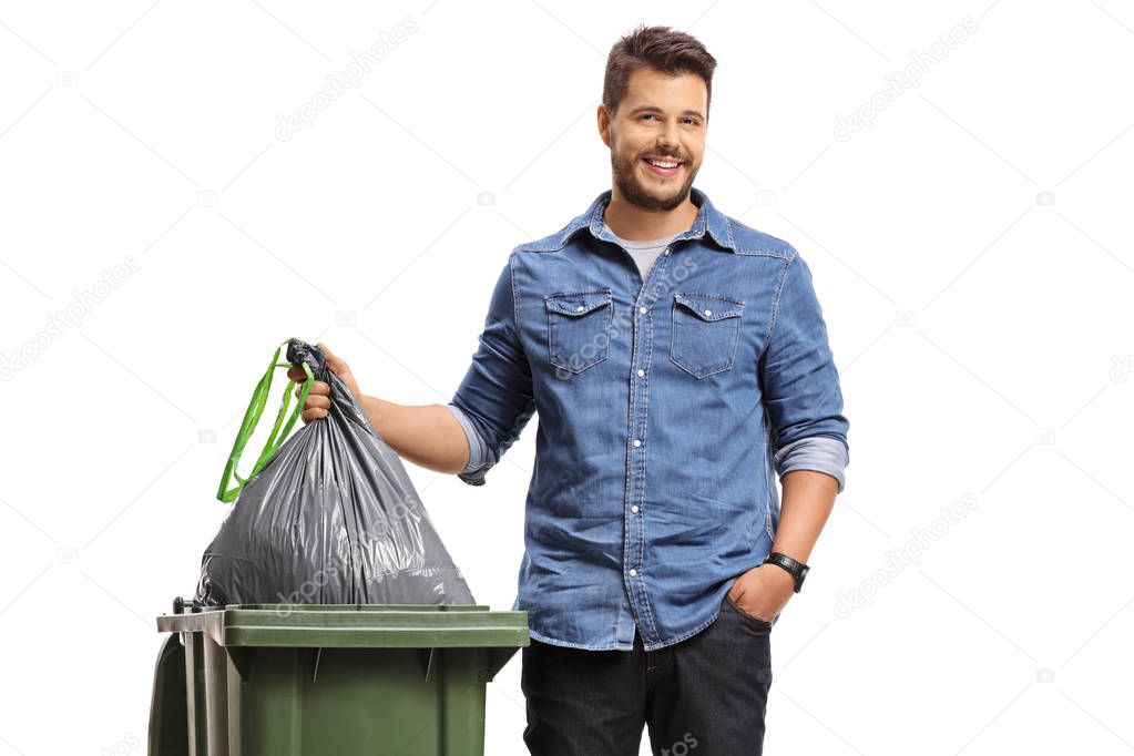 Young man taking out the garbage isolated on white background
