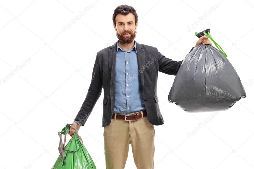 Young man holding trash bags isolated on white background