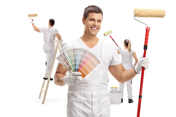 Painter Holding Color Swatch Paint Roller Two Painters Painting Him — Stock Photo, Image