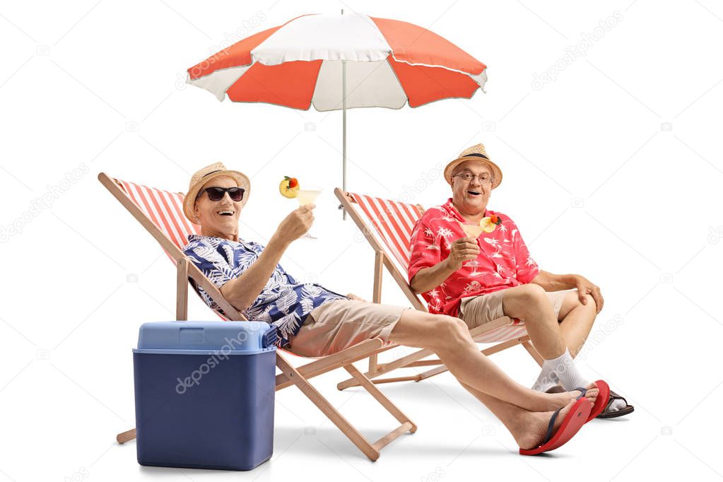 Elderly tourists with cocktails sitting in deck chairs isolated on white background