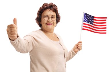 Bir Amerikan bayrağı tutarak ve beyaz arka plan üzerinde izole işareti bir başparmak yapma yaşlı kadın