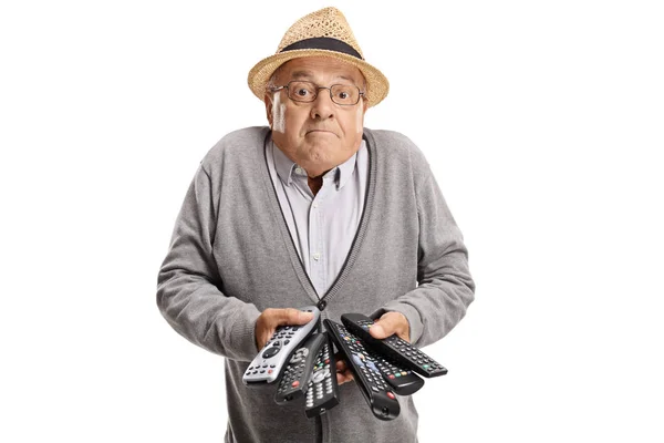 Verwarde Bejaarde Man Met Remotes Geïsoleerd Witte Achtergrond — Stockfoto