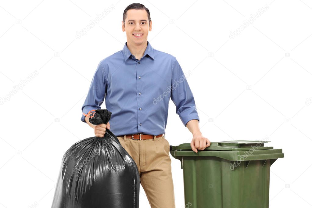 Young man with a trash bag and a garbage can isolated on white background