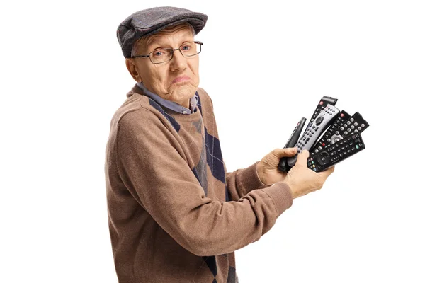 Confused Senior Holding Bunch Remotes Isolated White Background — Stock Photo, Image