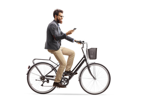 Young man riding a bicycle and looking at his phone isolated on white background