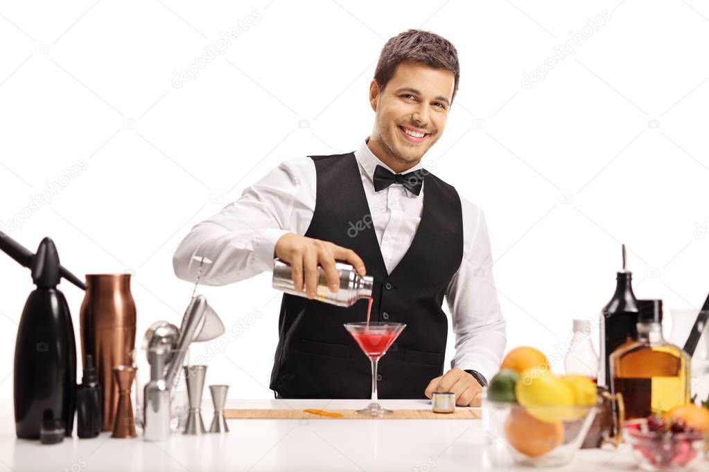 Bartender pouring his signature cocktail in a glass isolated on white background