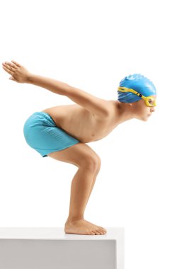 Full length profile shot of a little boy swimmer ready to jump isolated on white background clipart
