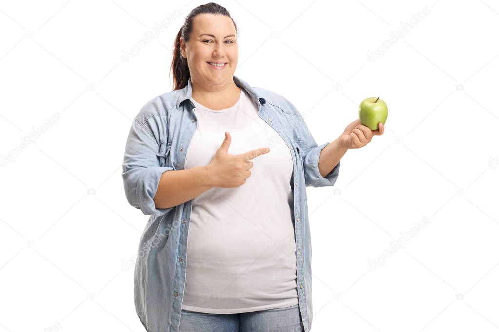 Overweight woman with an apple pointing isolated on white background