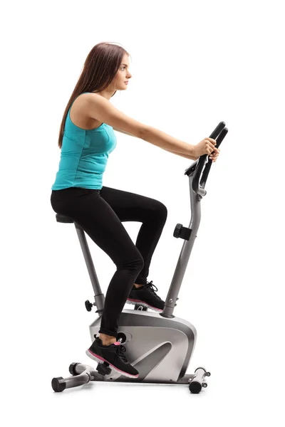 Full Length Portrait Young Female Riding Stationary Bike Isolated White — Stock Photo, Image