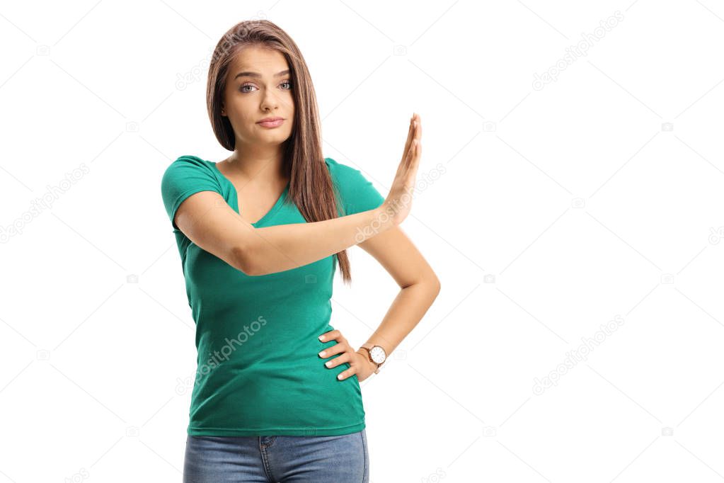 Beautiful young woman gesturing stop with her hand isolated on white background