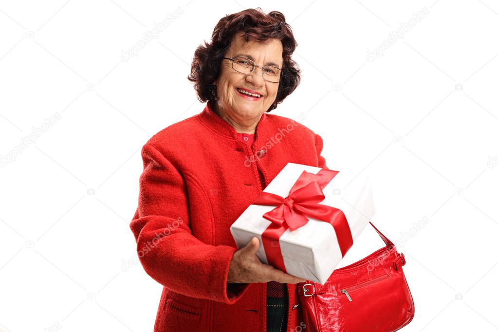 Elderly woman holding a gift in a box isolated on white background