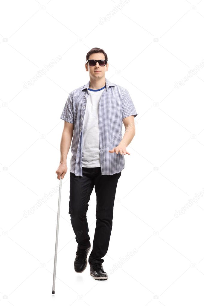 Full length portrait of a blind man walking isolated on white background