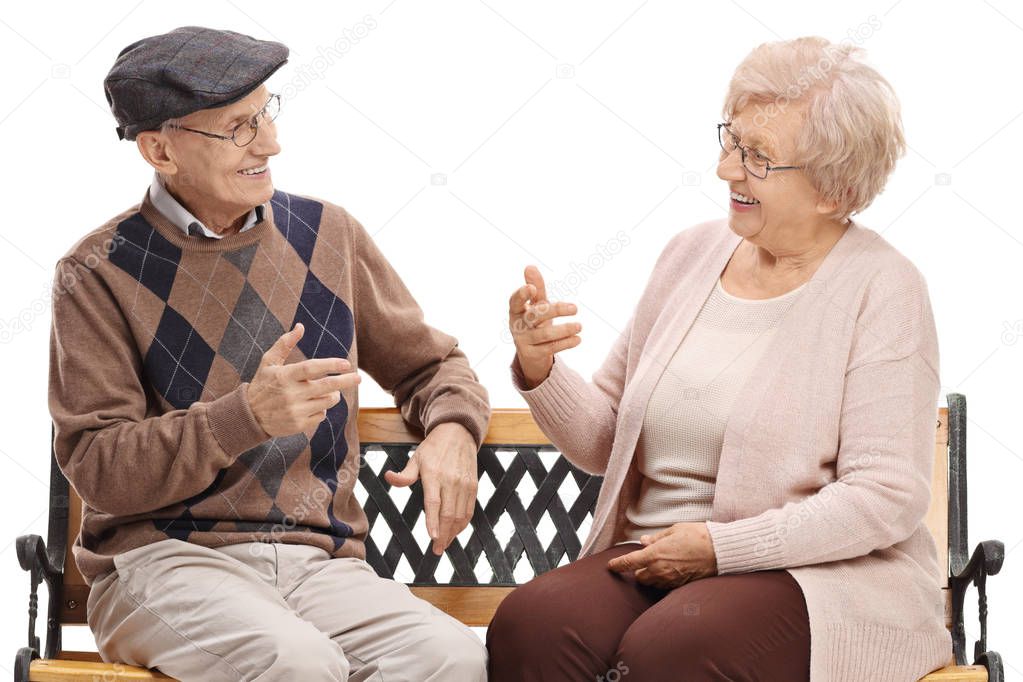 Seniors sitting on a bench and talking isolated on white background