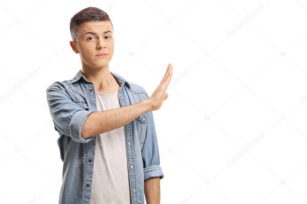 Young male gesturing stop with his hand isolated on white background
