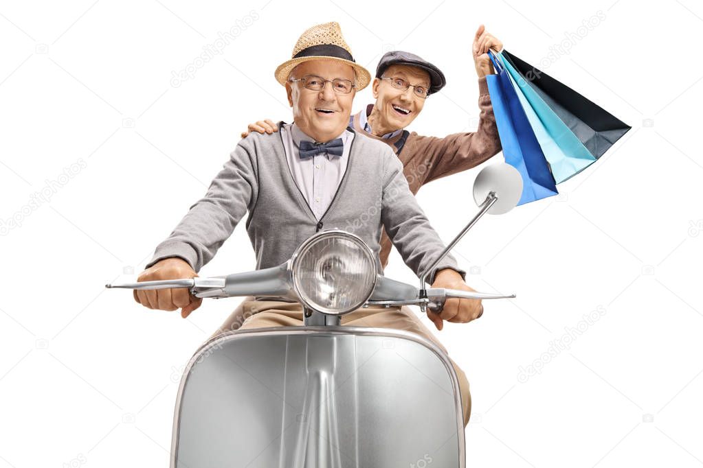 Two senior men riding on a vintage scooter, one holding shopping bags isolated on white background