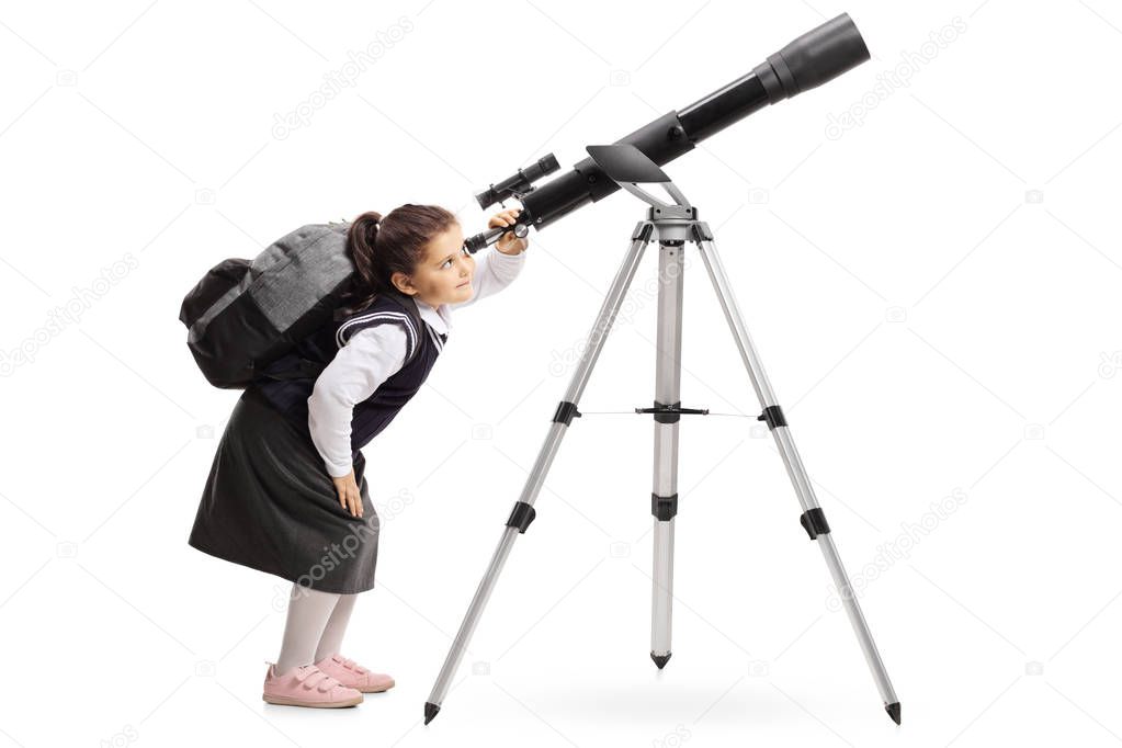 Schoolgirl with a backpack looking through a telescope isolated on white background