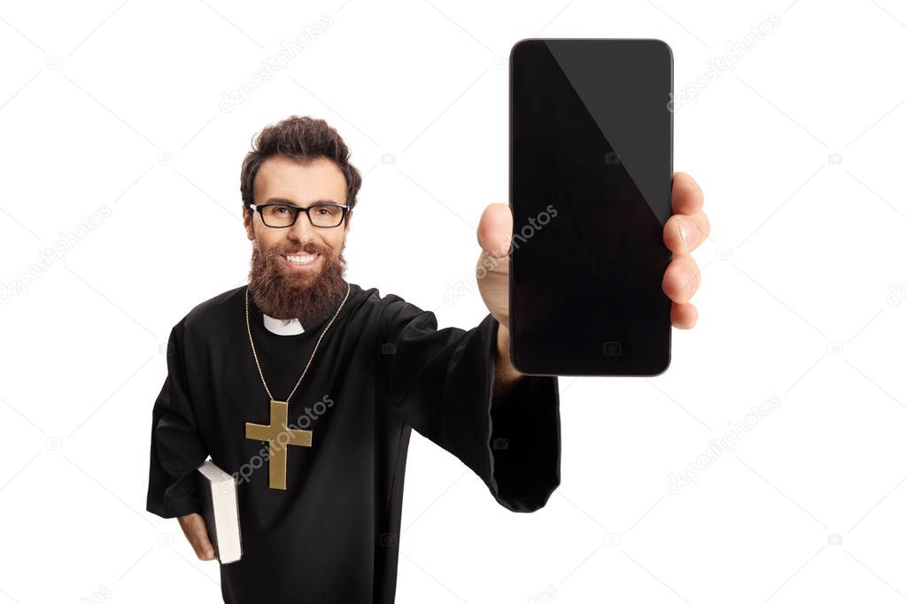 Young priest holding a mobile phone isolated on white background