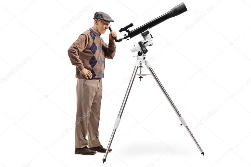 Full length shoit an elderly man looking through a telescope isolated on white background