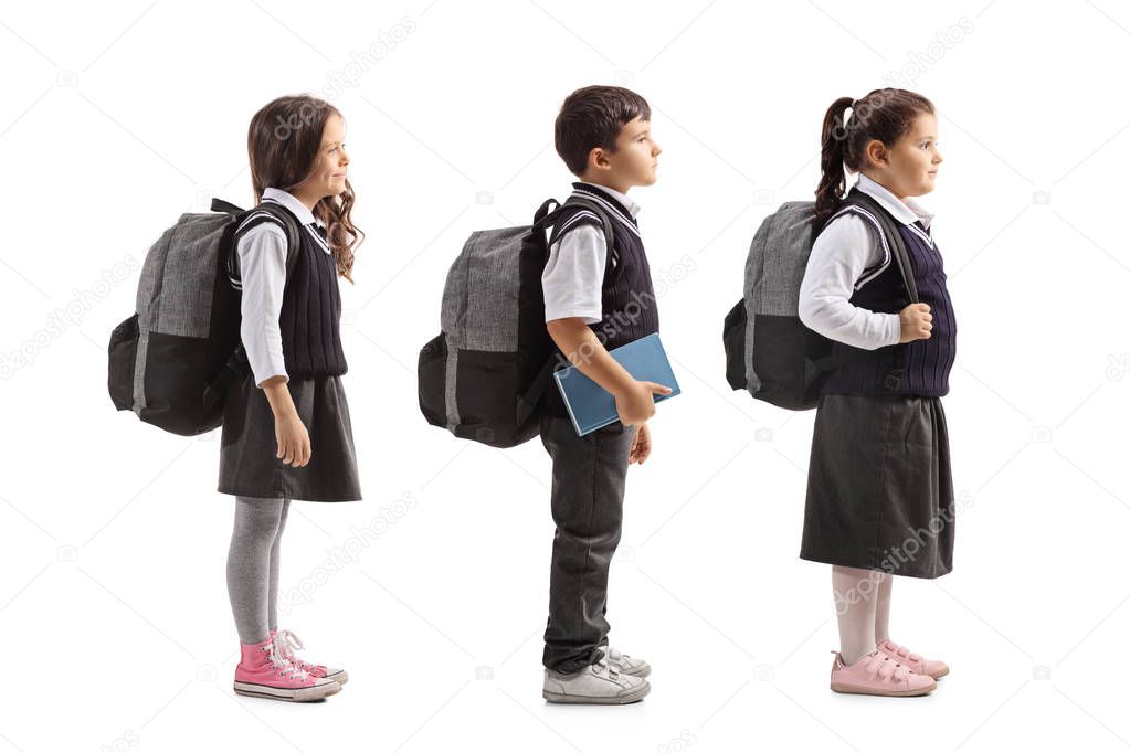 Full length profile shot of schoolchildren waiting in line isolated on white background