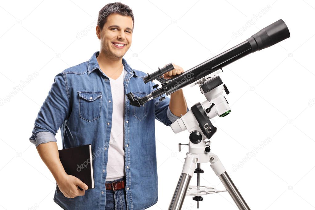 Smiling young man with a telescope isolated on white background