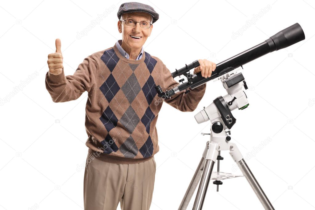 Senior man with a telescope looking at the camera and giving thumb up isolated on white background