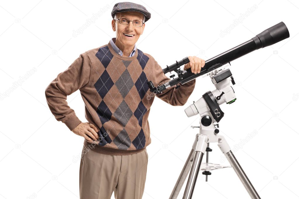 Smiling senior man with a telescope looking at the camera isolated on white background