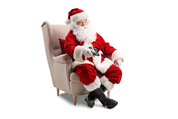 Santa Claus Sitting Armchair Holding Remote Controller Isolated White Background — Stock Photo, Image