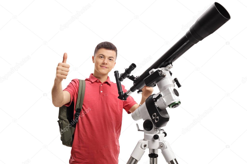 Male student with a telescope showing thumbs up isolated on white background