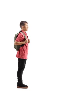 Full length profile shot of a young schoolboy waiting in line isolated on white background clipart