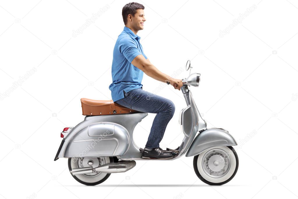 Smiling young man riding a vintage scooter isolated on white background