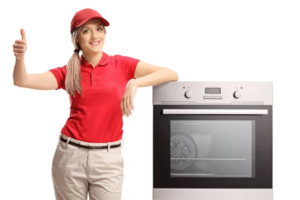 Salesgirl Appoggiata Forno Elettrico Dando Pollice Isolato Sfondo Bianco — Foto Stock