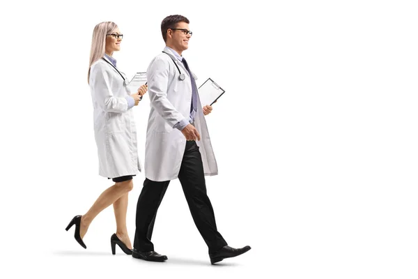 Full Length Profile Shot Male Female Doctor Clipboard Walking Isolated — Stock Photo, Image