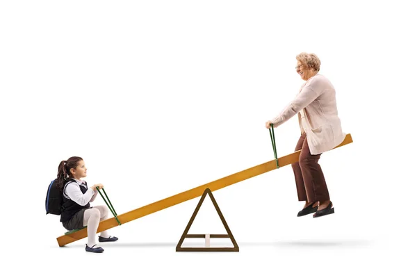 Little Schoolgirl Elderly Woman Playing Seesaw Isolated White Background — Stock Photo, Image