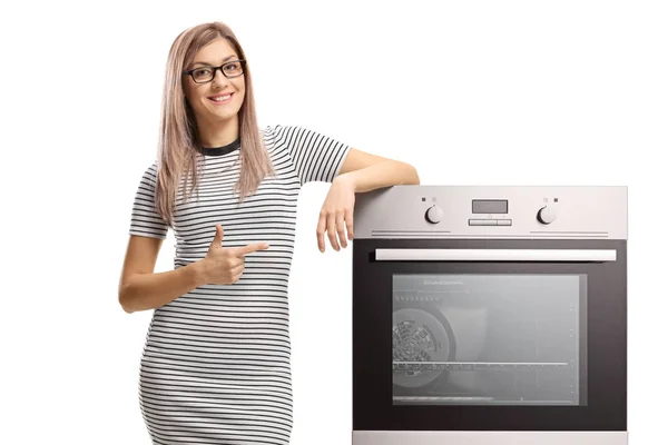 Young Smiling Woman Pointing Electric Oven Isolated White Background — Stock Photo, Image