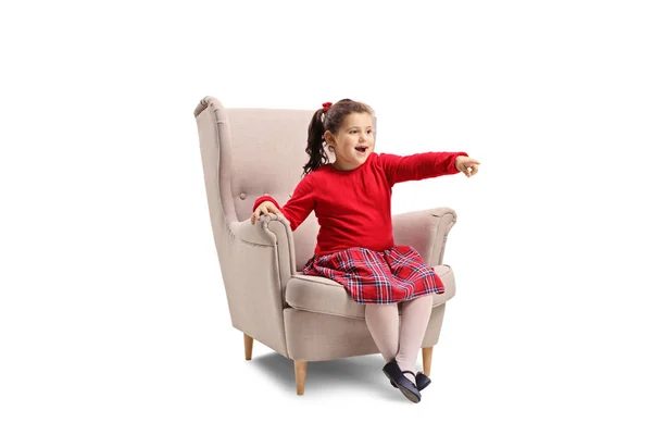 Full Length Shot Little Girl Sitting Armchair Pointing Her Finger — Stock Photo, Image