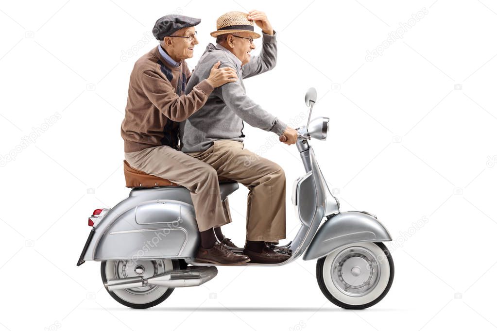 Full length shot of two senior men riding a vintage scooter fast isolated on white background