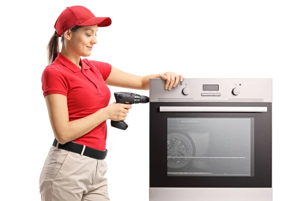 Mulher Reparando Forno Com Uma Broca Isolada Sobre Fundo Branco — Fotografia de Stock