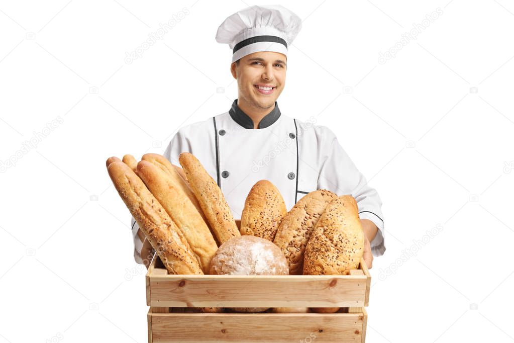 Young male baker holding a box with different types of bread isolated on white background