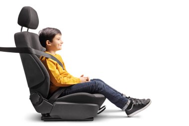 Little boy sitting in a car seat strapped up isolated on white background clipart