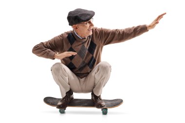 Energetic senior man riding a skateboard isolated on white background clipart