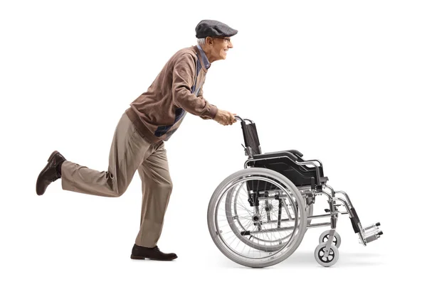 Full Length Profile Shot Elderly Man Running Pushing Empty Wheelchair — Stock Photo, Image