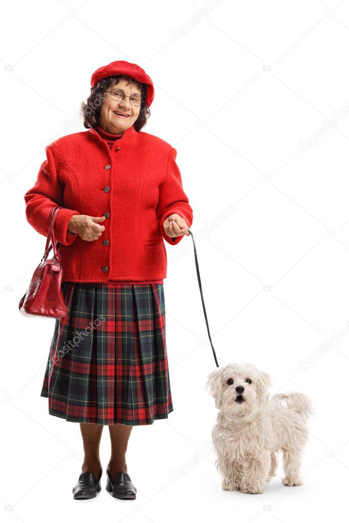 Full length portrait of an older lady with a maltese poodle dog isolated on white background
