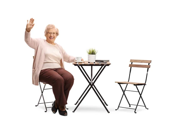 Full Length Portrait Elderly Woman Sitting Table Cup Coffee Waving — Stock Photo, Image