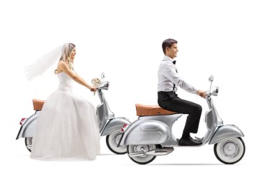 Full length profile shot of a bride and groom riding vintage scooters isolated on white background clipart